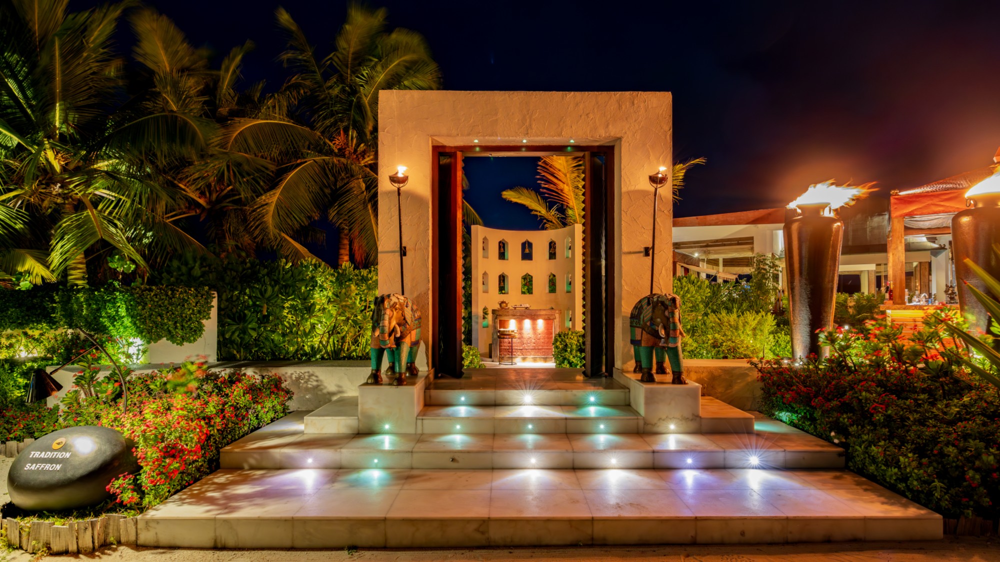 Exterior of restaurant, Saffron, lit up at night with elephants