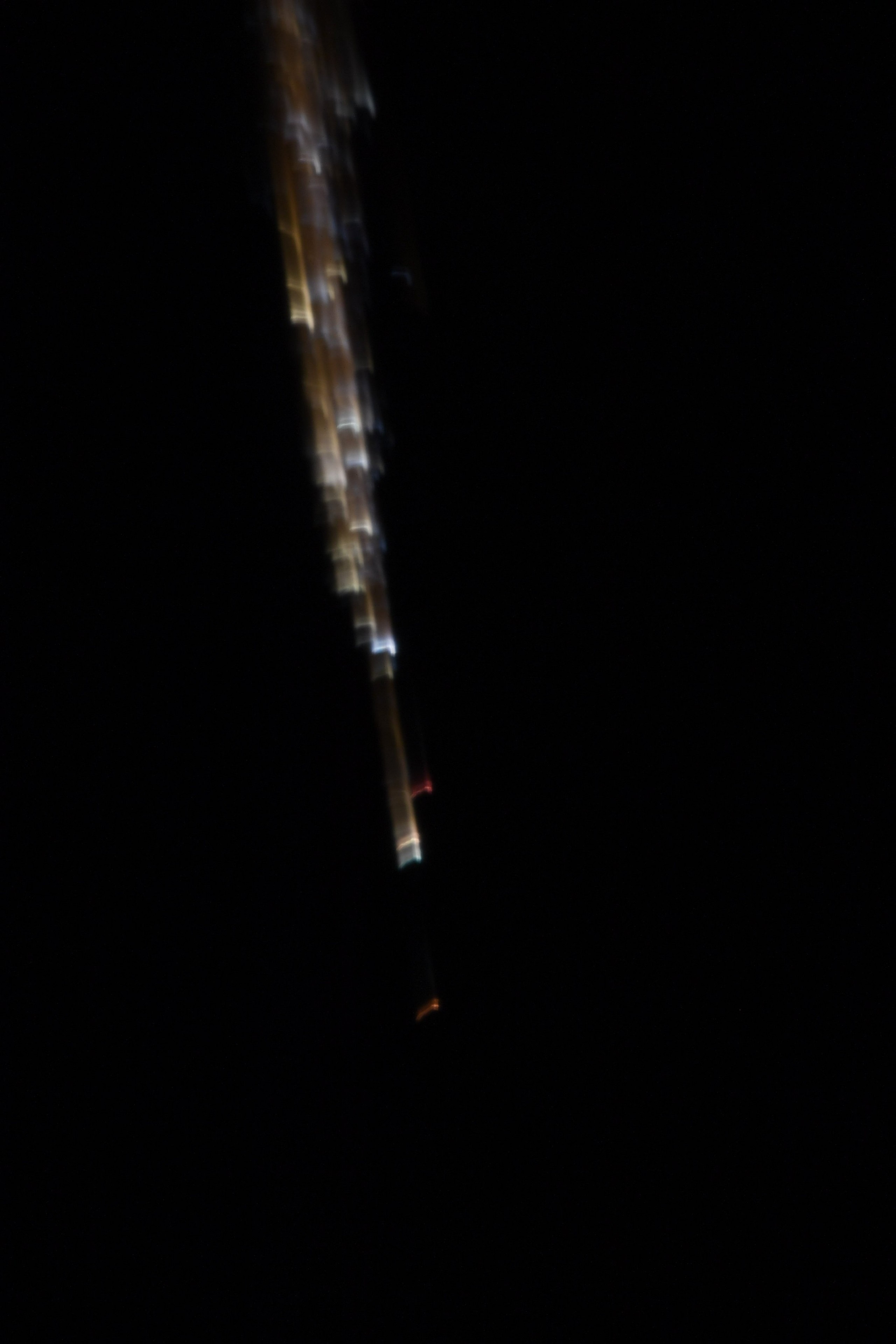 bright trails of fire can be seen against the blackness of space