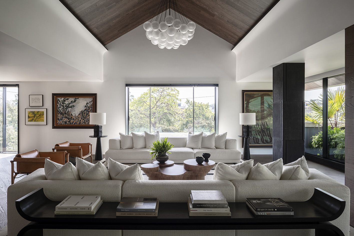 Apartment interior with white sofas and chandelier 