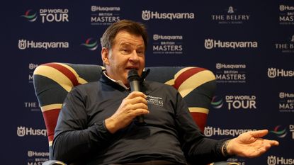 Sir Nick Faldo speaks into a microphone while sat in a Union Jack chair ahead of the 2026 British Masters