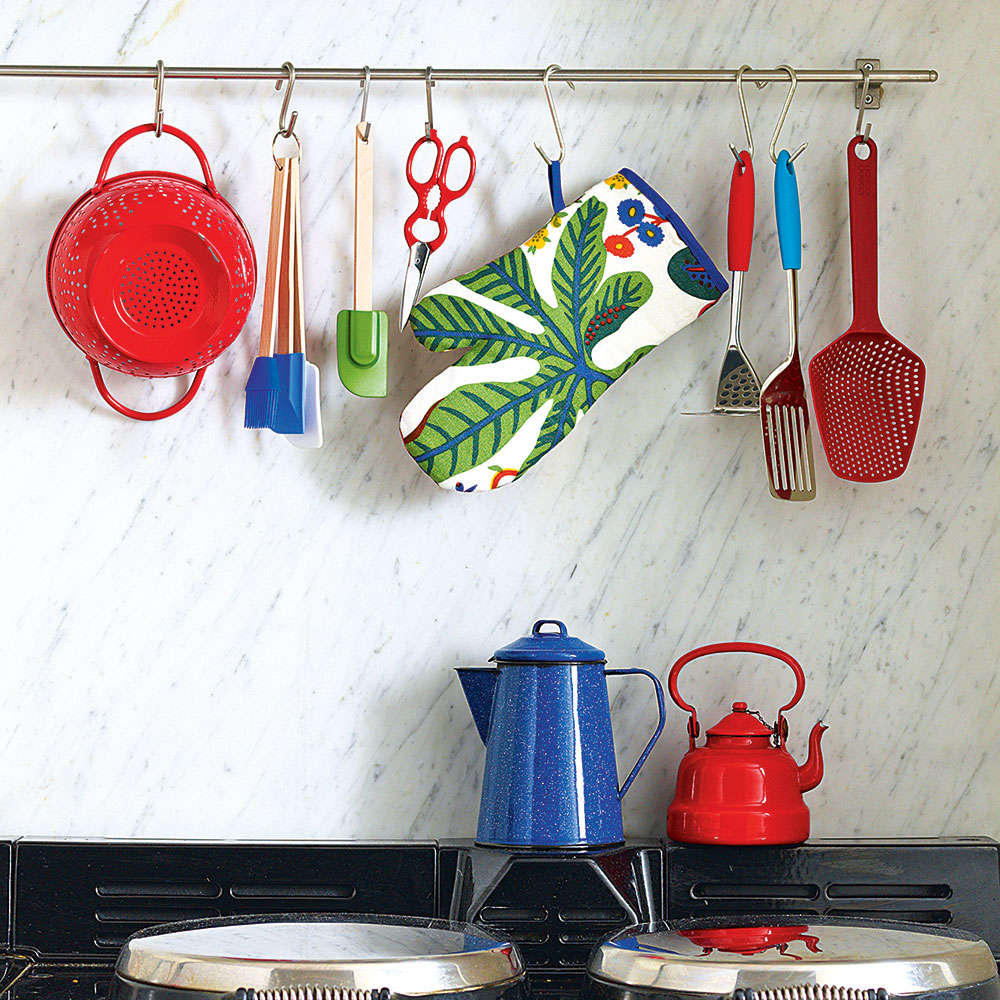 kitchen with handrail white tiles on wall and scissor cooktop