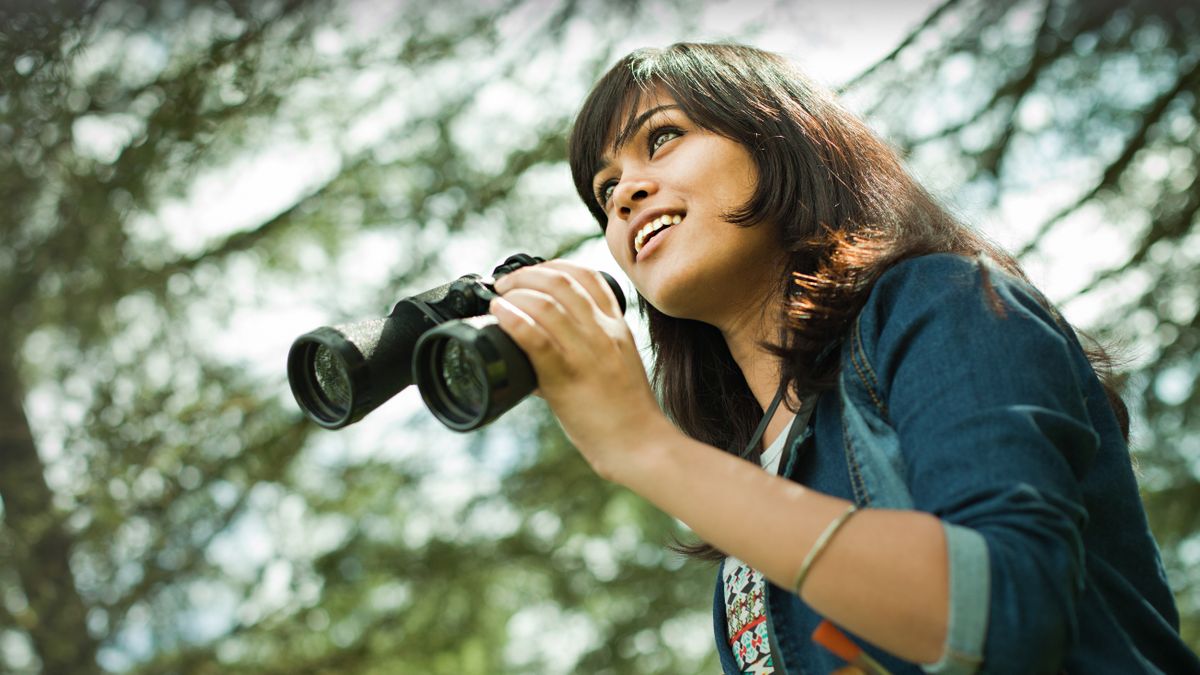 Women holding a pair of the Best budget binoculars under $100 in the forest