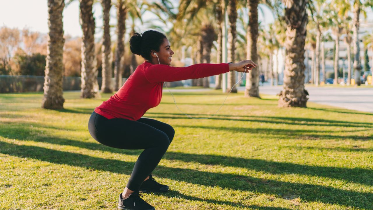 Woman doing a bodyweight squat outside