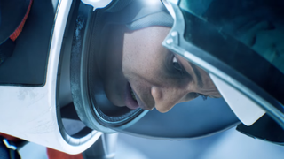A woman in an astronaut suit looks down with a vexed expression.
