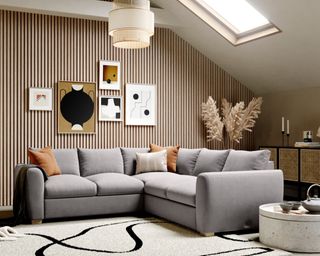 A grey velvet corner sofa in a modern apartment