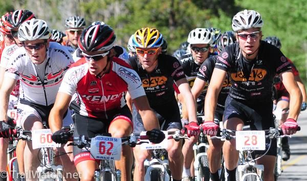 The men's peloton heads uphill at a blistering pace.