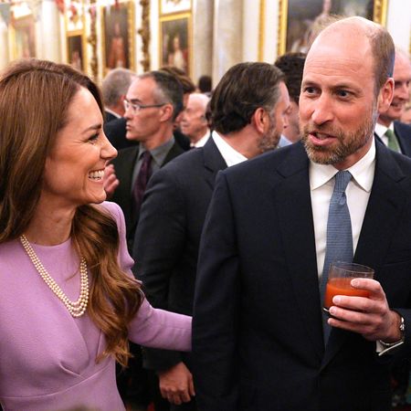 Prince William and Princess Kate laughing at a palace reception 