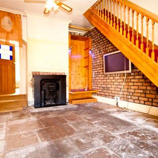 hallway with fireplace and television