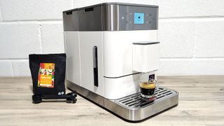 KitchenAid Fully Automatic Espresso Machine KF6 with coffee beans and scoop on kitchen counter