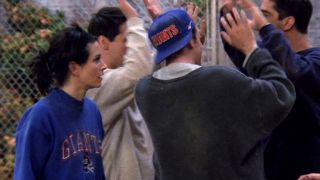Monica and Chandler wearing Giants shirt and hat on Friends.