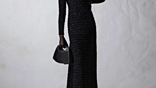 Bang & Olufsen/Balenciaga Speaker Bag held by a woman in a black dress