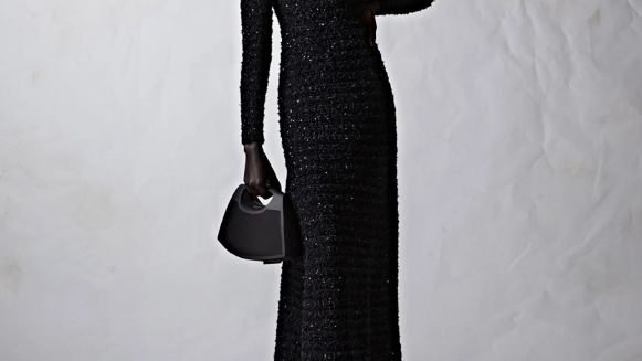 Bang &amp; Olufsen/Balenciaga Speaker Bag held by a woman in a black dress