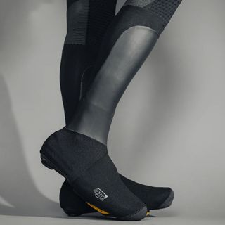 A rider wearing the Spatz Pro Stealth overshoe system