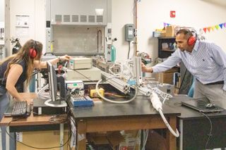 The University of Central Florida's Jessica Chambers and Kareem Ahmed set up the shock tube they used to help uncover the mechanisms that drive Type IA supernova explosions.