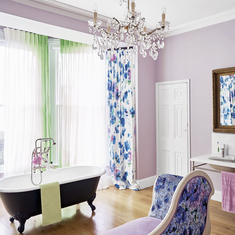 bathroom with curtains on window and bathtub