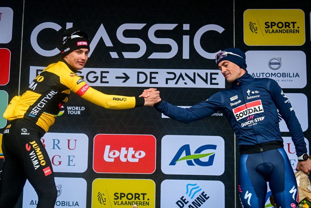 JumboVismas Dutch rider Olav Kooij L shakes hands with Soudal QuickSteps Belgian rider Yves Lampaert as they celebrate on the podium after the mens elite race of the Classic BruggeDe Panne oneday cycling race 2074km from Brugge to De Panne on March 22 2023 Photo by ERIC LALMAND Belga AFP Belgium OUT Photo by ERIC LALMANDBelgaAFP via Getty Images