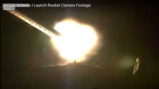 The Space Launch System rocket shedding its solid booster shortly after its debut lift-off.