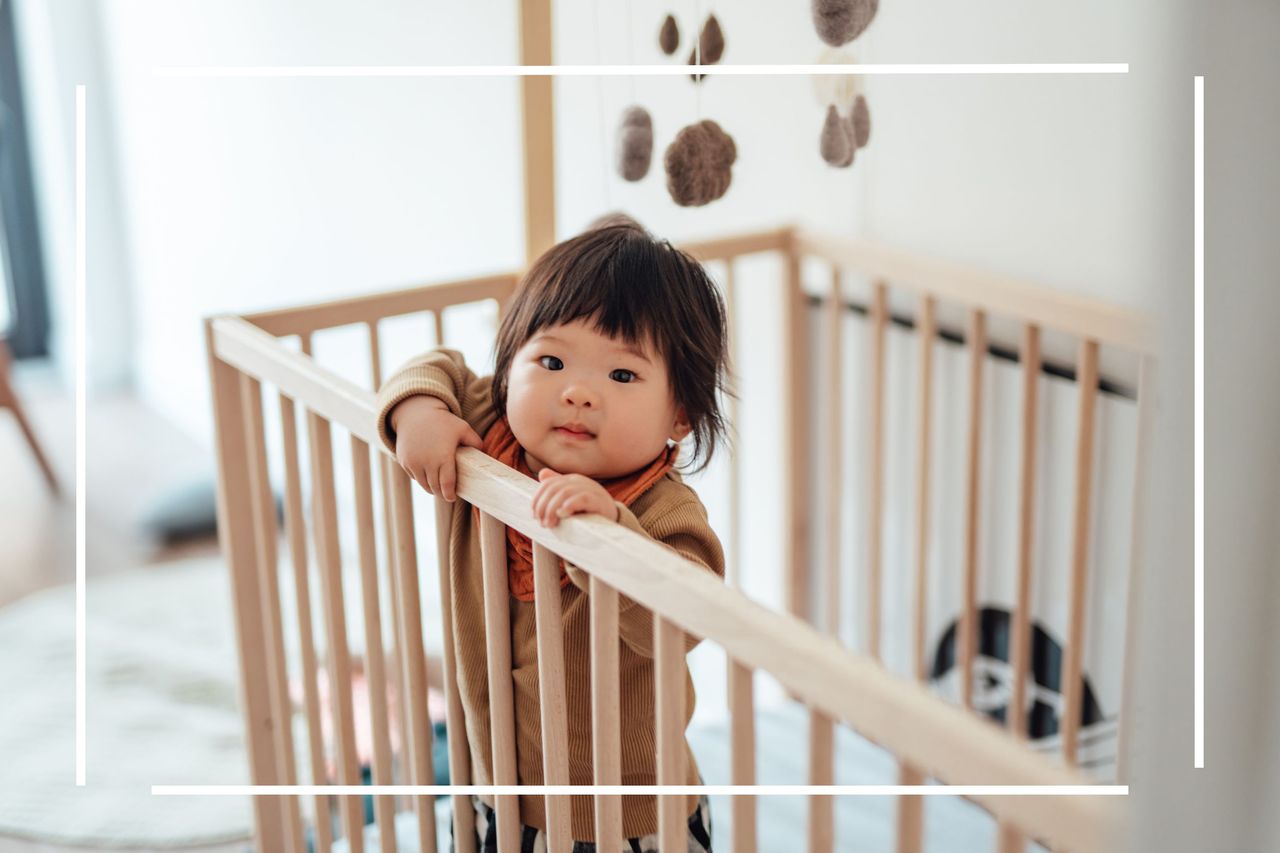 Baby names 2023 illustrated by baby standing up in cot