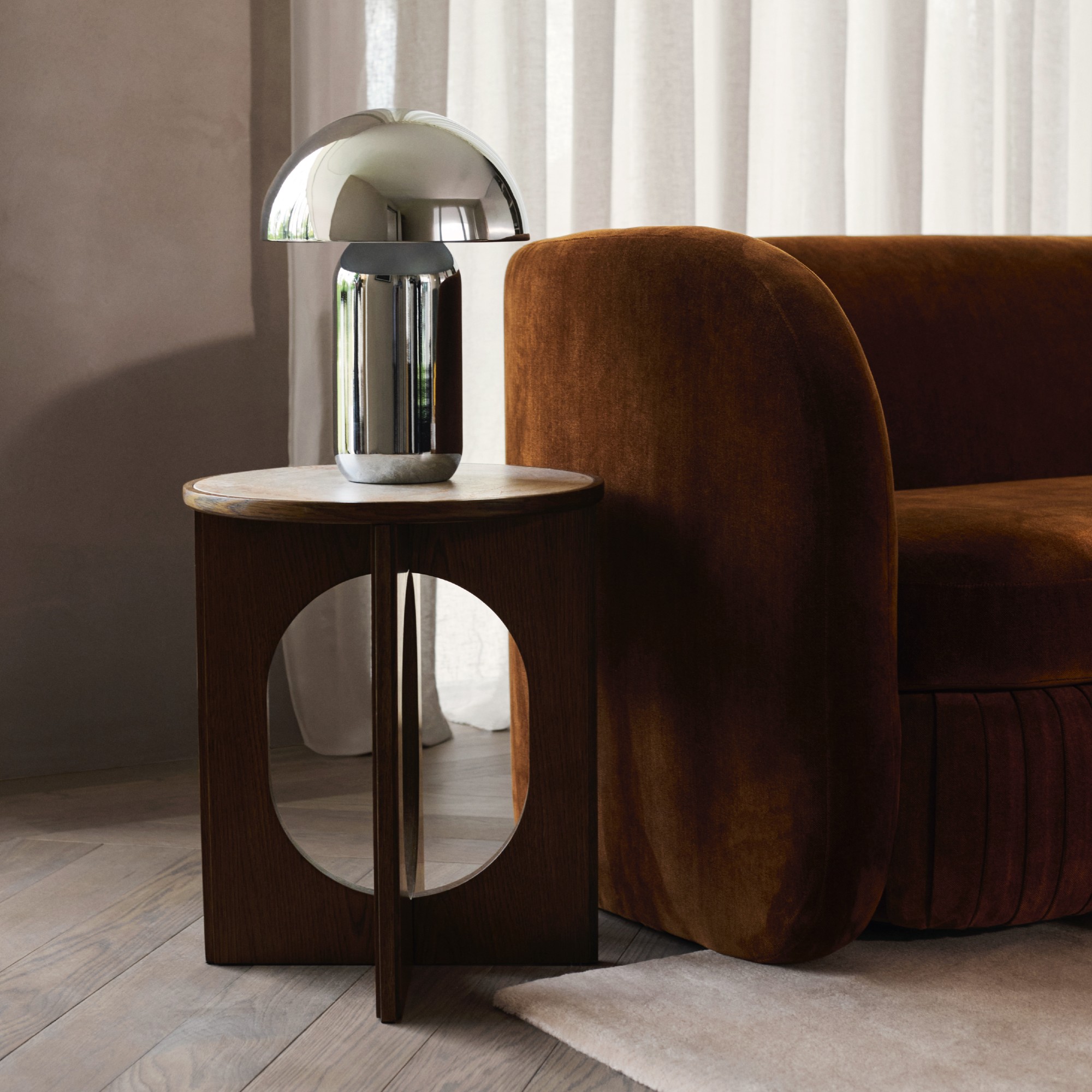 John Lewis Pleat sofa in Ginger Chenille in a minimalist living room with a round side table and a chrome table mushroom lamp on top