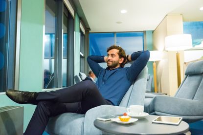 Contemplated businessman relaxing at airport lounge