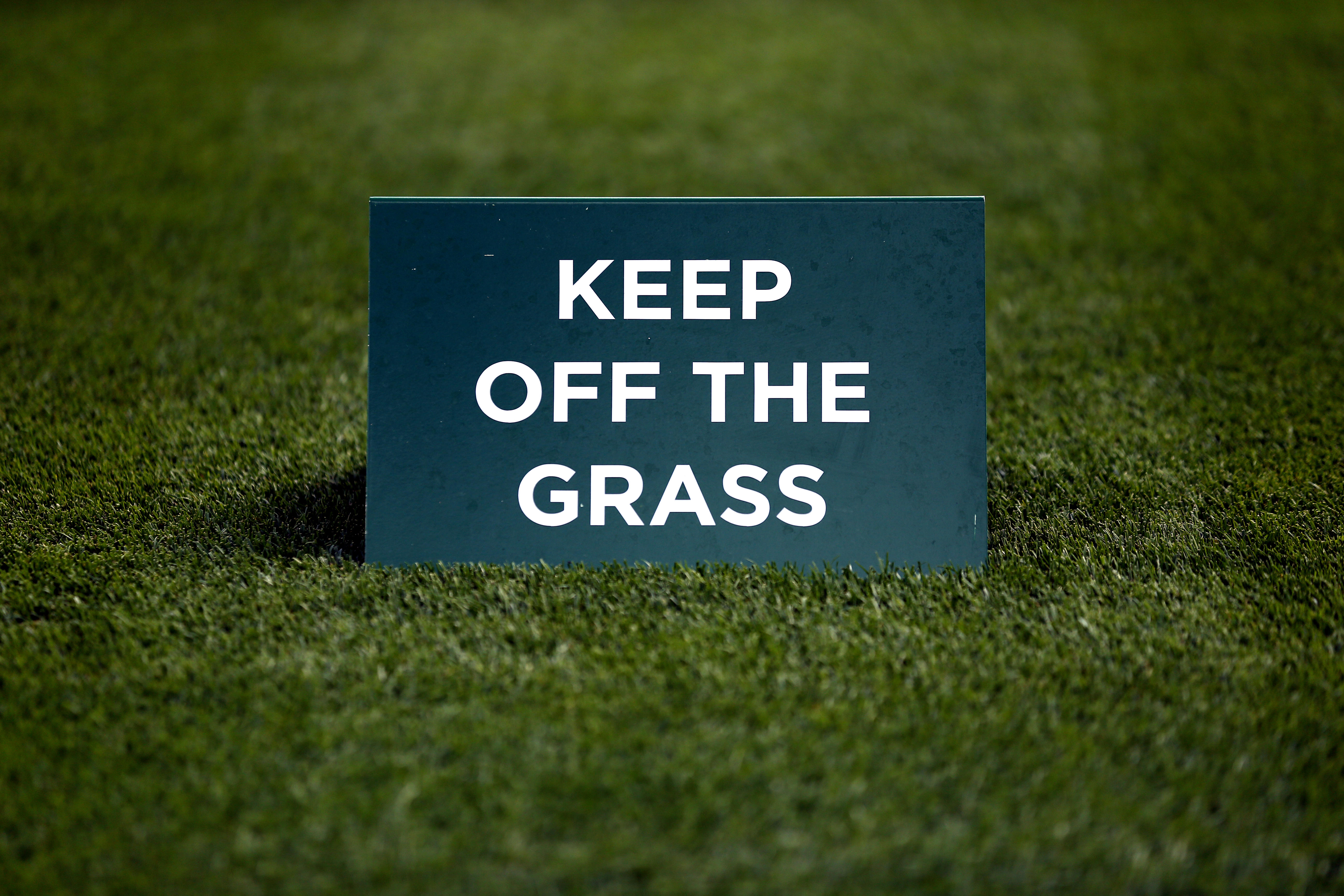A keep off the grass sign at the Wimbledon championships
