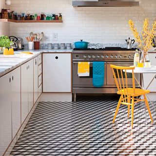 kitchen with geometric monochrome flooring and yellow chairs