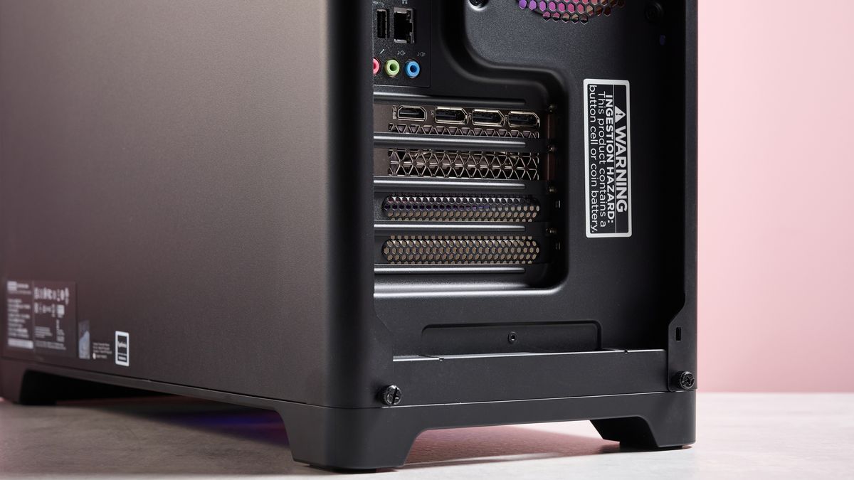 Close-up of bottom-rear portion of the Lenovo Legion Tower 5, with pink wall in background