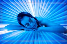 A woman lying face down on a sunbed