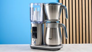 the breville luxe brewer (sage luxe brewer in the UK) thermal carafe version with a silver metal carafe and filter basket and removable plastic water tank showing the range of filter baskets and paper filters with a dial to control brew