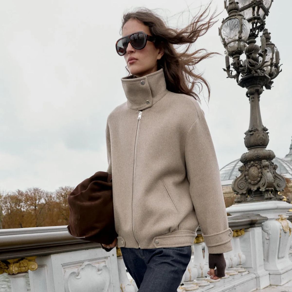 Woman wears funnel-neck coat