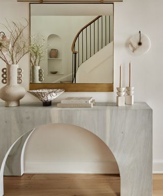 Hallway mirror on top of geometric grey wooden table