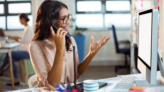 woman using a voip phone in the office