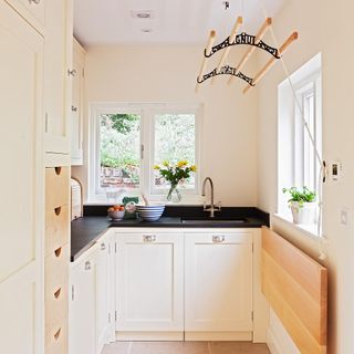 White small kitchen with black worktop