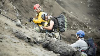Will Smith (left) descends into a volcano alongside volcanologist Jeff Johnson (middle) and explorer Erik Weihenmayer (right).