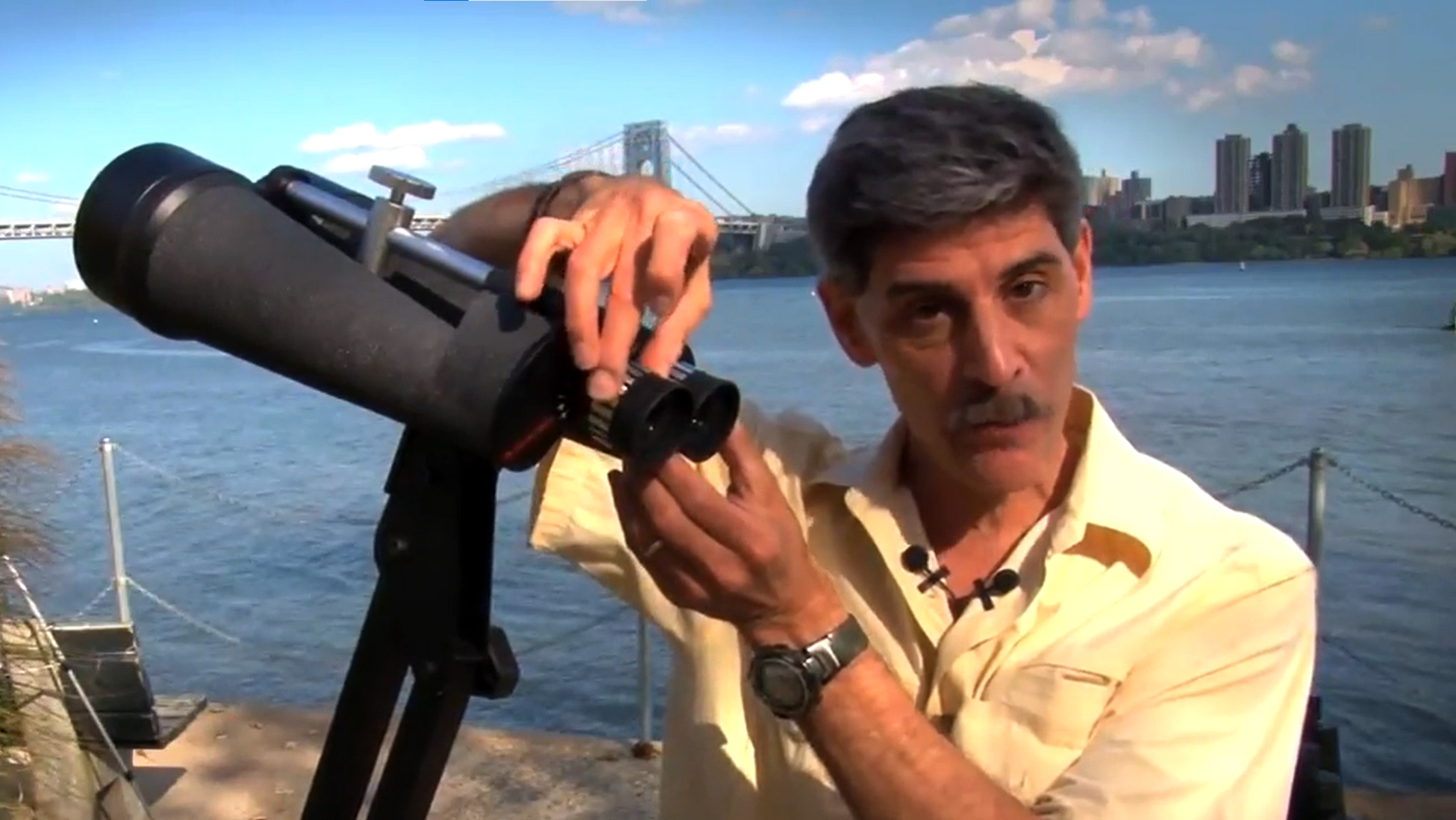 Celestron Skymaster 25x100 binoculars being handled on a tripod by the author