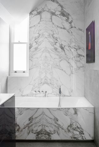 marble bathroom with sloping roof