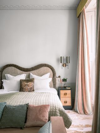 Grey bedroom with long pink curtains