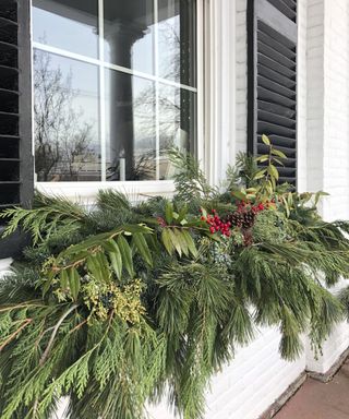 Christmas porch decor window garland with fresh foliage pinecones and berries