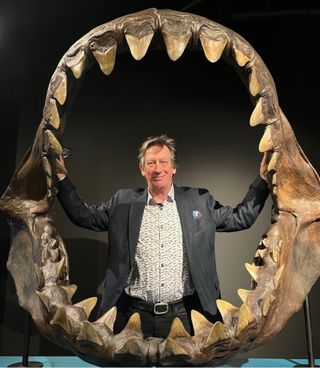 John Long stands inside the old jaws of a Megalodon.