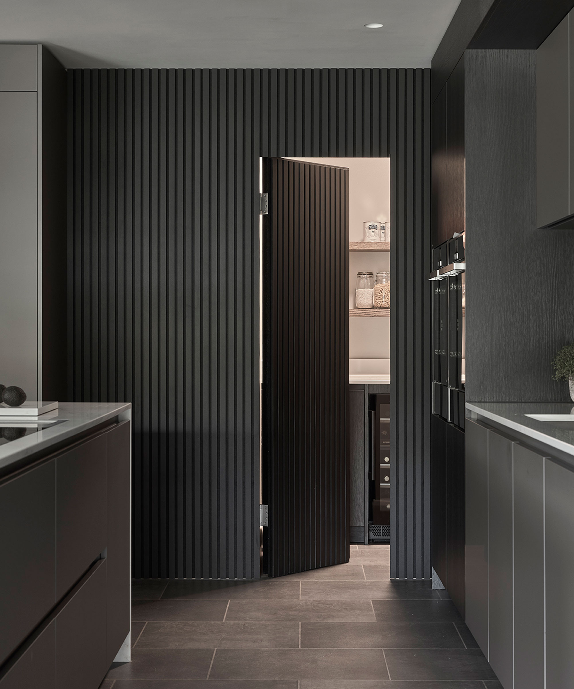 black fluted kitchen with handless units
