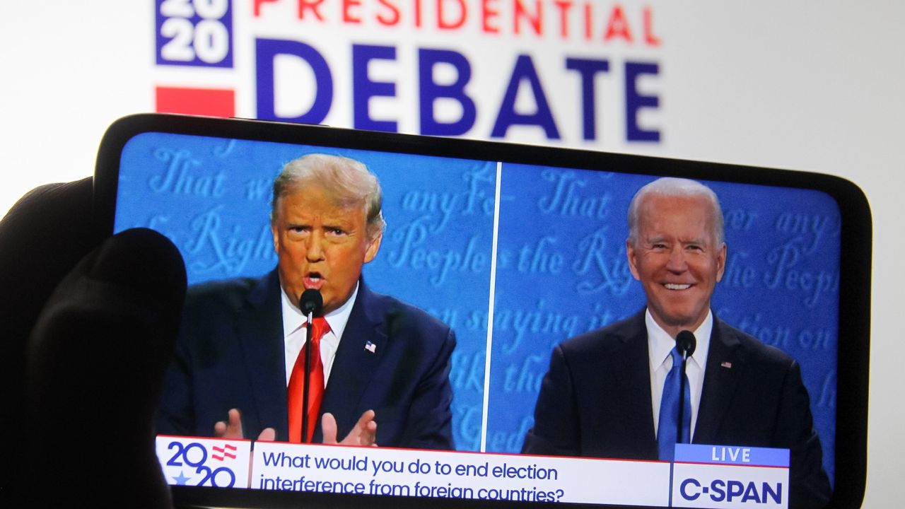 2020 presidential debate between Donald Trump and Joe Biden seen on the screen of a smartphone