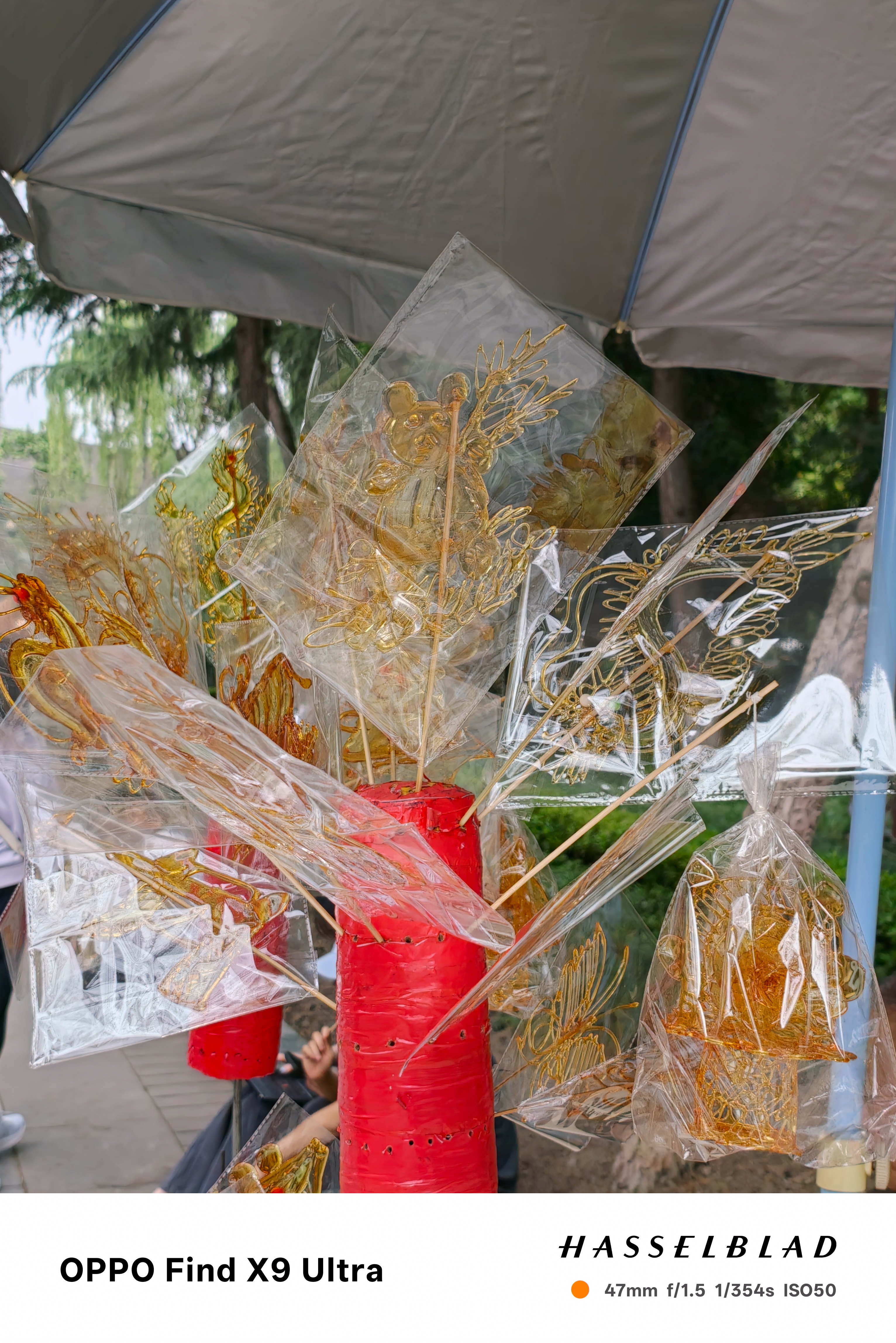 Close-up of packaged sugar art shapes hanging from red display stands