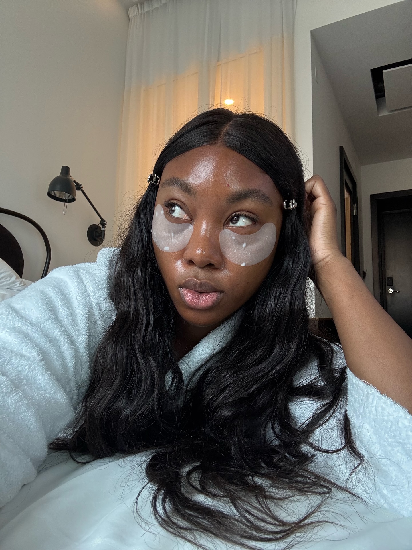 Nnenna Echem with dewy, even-toned skin and under eye patches