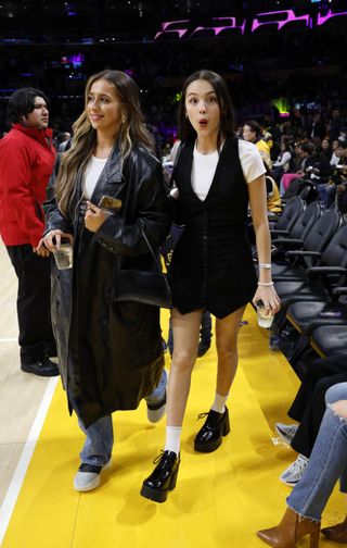 Olivia Rodrigo and Tate McRae attend the basketball game between the Los Angeles Lakers and Brooklyn Nets.