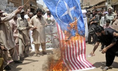 Pakistani protesters burn representations of U.S. and NATO flags