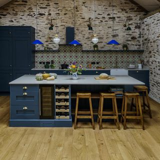 kitchen with white countertop and navy blue cabinet with wooden flooring