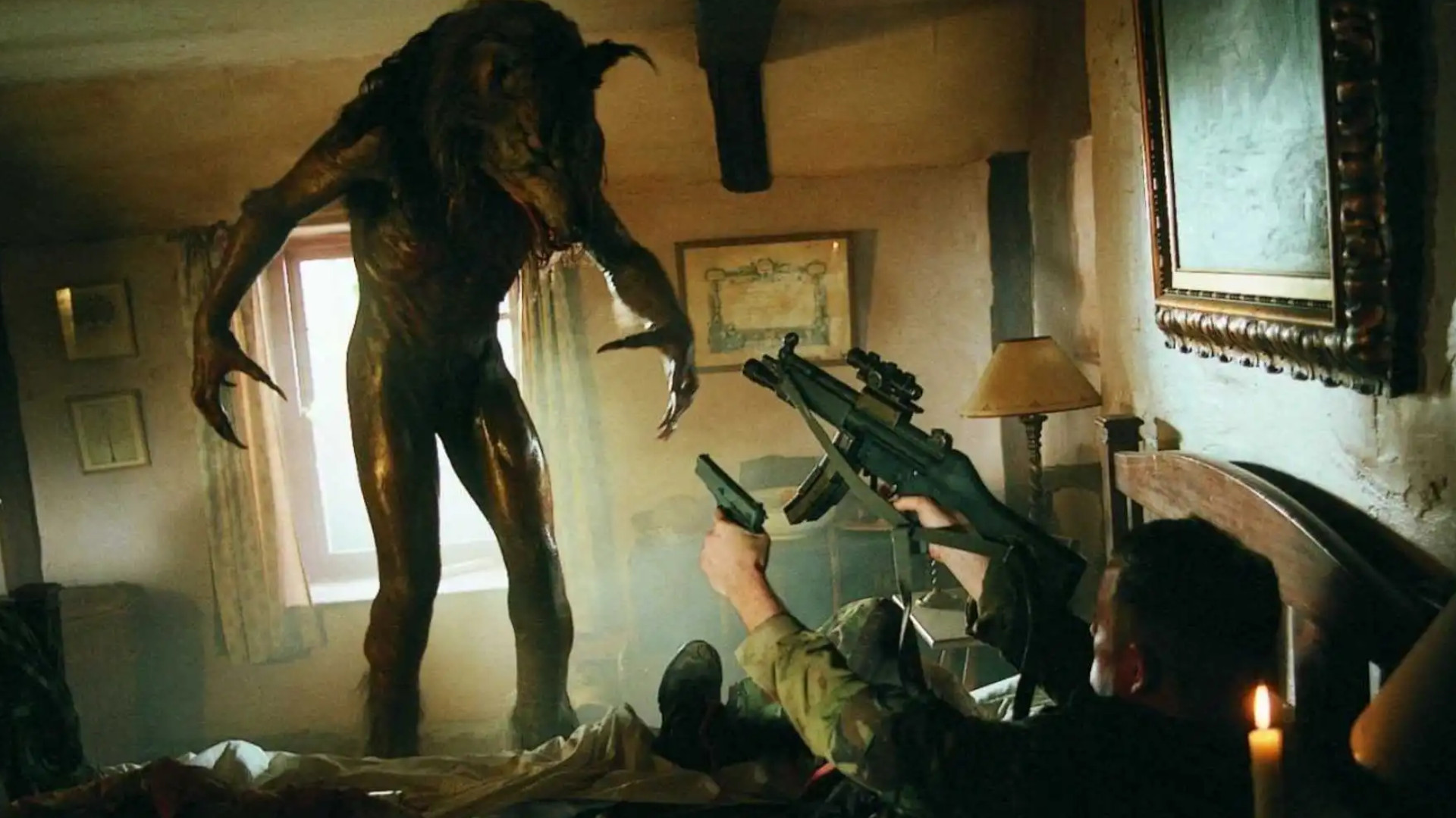 A soldier pointing a gun at a werewolf during one of the best scary movies, Dog Soldiers.