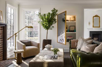 a living room with storage behind a painting