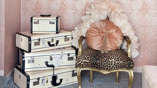 bedroom with arm chair and trunk boxes