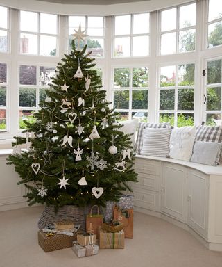 room with sash window christmas tree and wrapping gifts